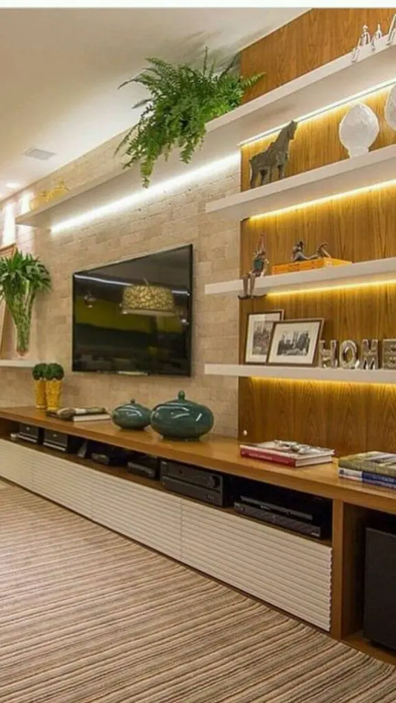 Cove lighting installed below the shelves in TV stand