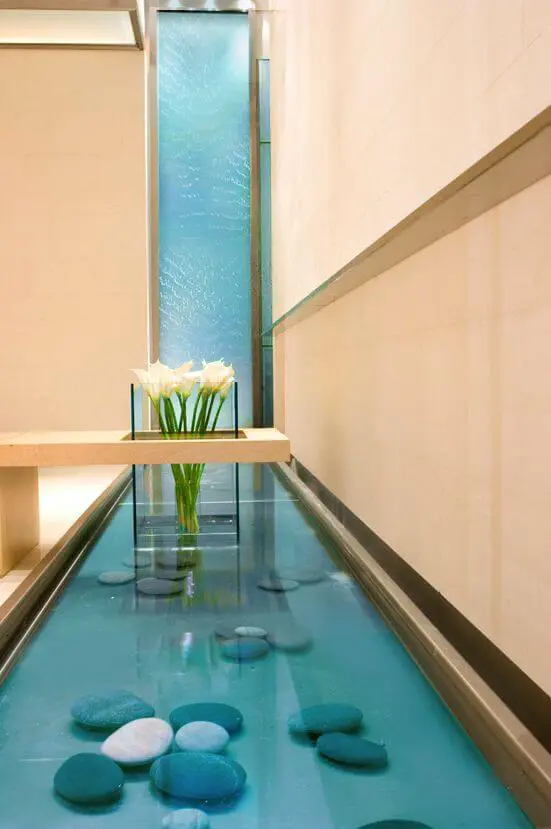 Water scaping with a pool of water and stone pebbles