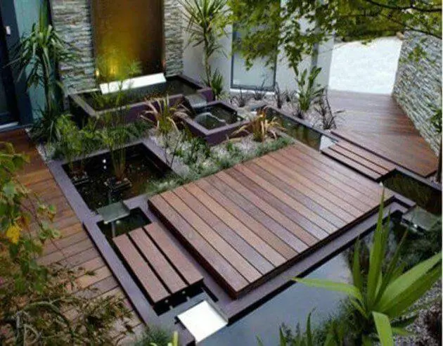 green garden courtyards in main entrance with a path to walk