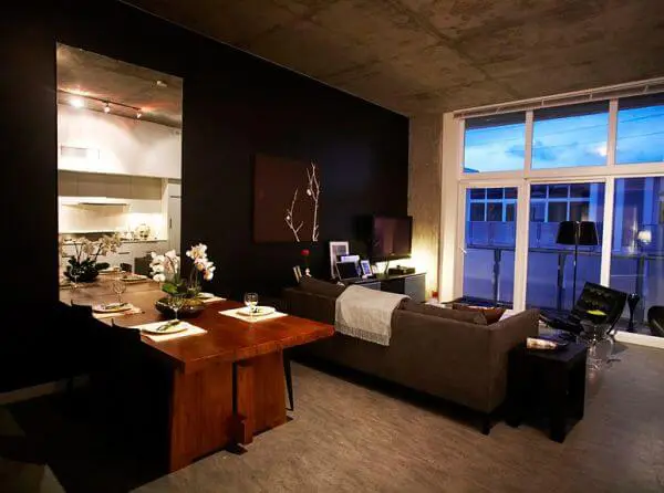 A minimalistic bachelor pad with dining and sofa in living room