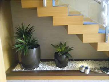 Potted plants underneath the staircase