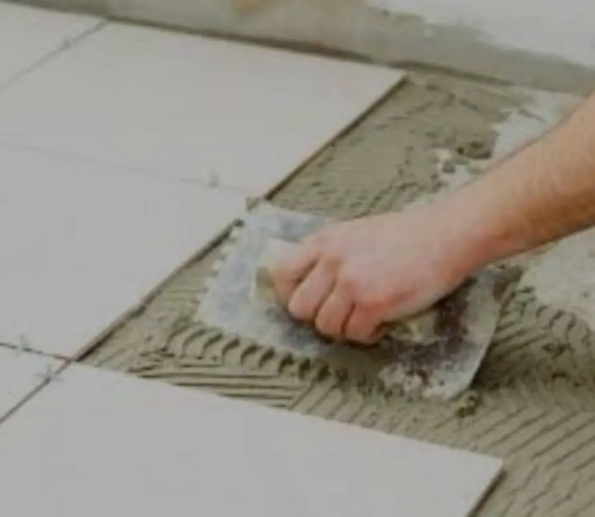 Spreading of cement motar for laying tiles