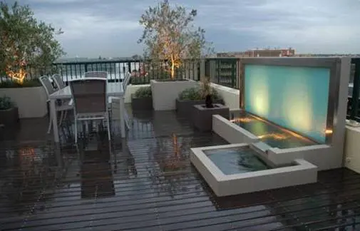 A small water fountain and a table placed on roof top