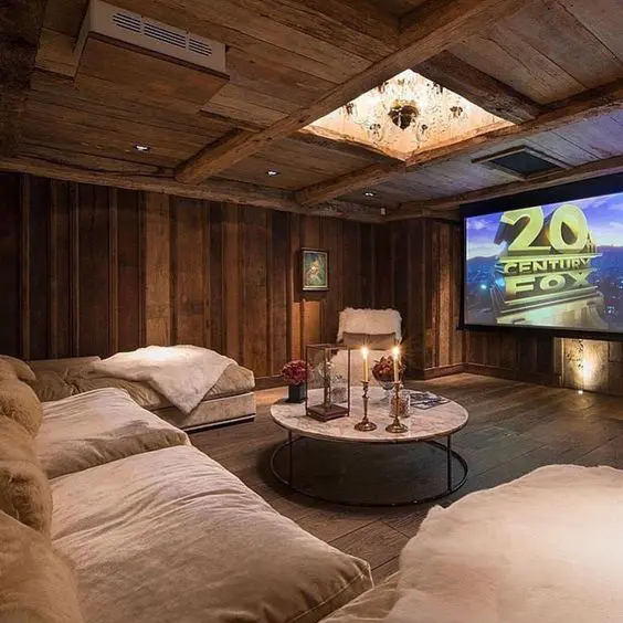A rustic looking room with natural lighting and sofa infornt of TV