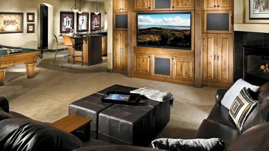 A basment converted into a living room with TV and sofa