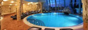 A round indoor swimmng pool with lighting scheme built in it