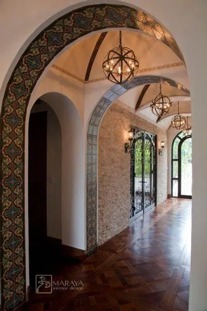 A stilted corridor leading inside the house from the entrance.