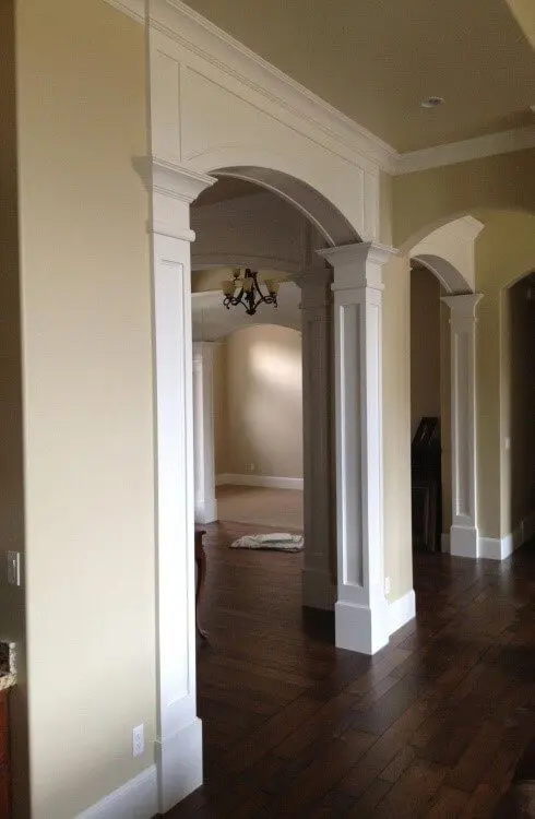 a simple arch with intricate moulding on the vertical piers