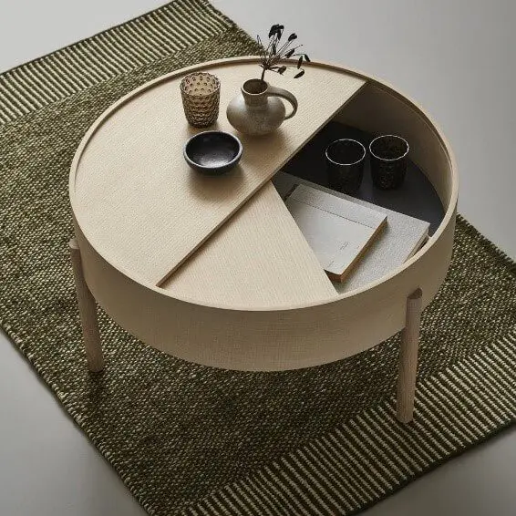 A hidden storage underneath the round coffee table top