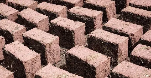 Sun dried Mud bricks reinforced with straw fibers