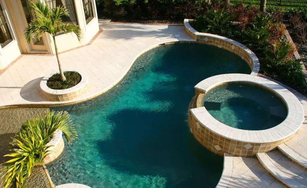 Kidney shaped swimming pool with a small pool for kids