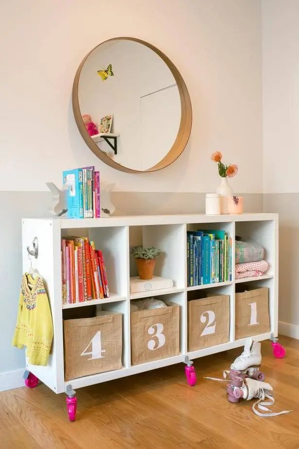 Open movable storage on wheels in kids room for storing books and toys