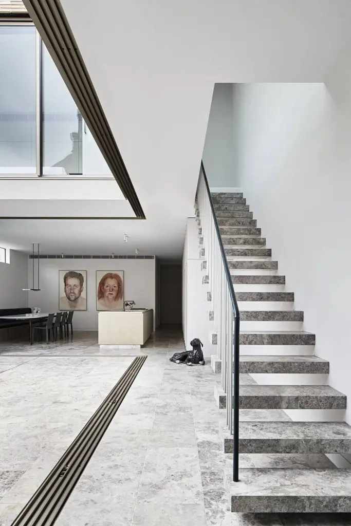 Marble finished floating staircase with glass handrail