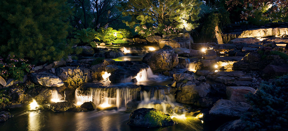 Landscape Lighting installed admist of rocks and waterfall