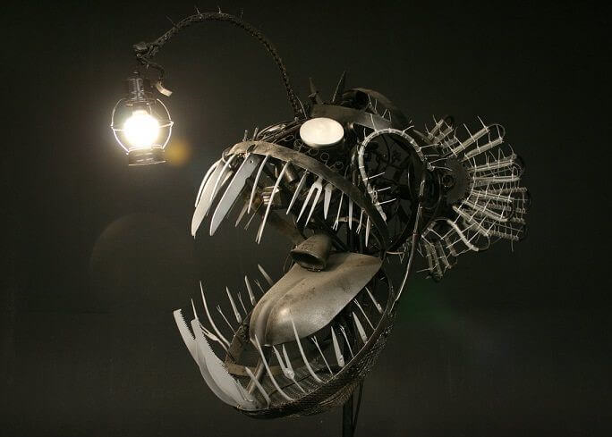 scrap construction materials used to create a fish shaped lighting fixture