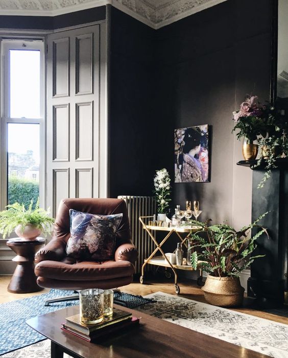 Dark coloured interiors paired with brown leather for Living Room areas