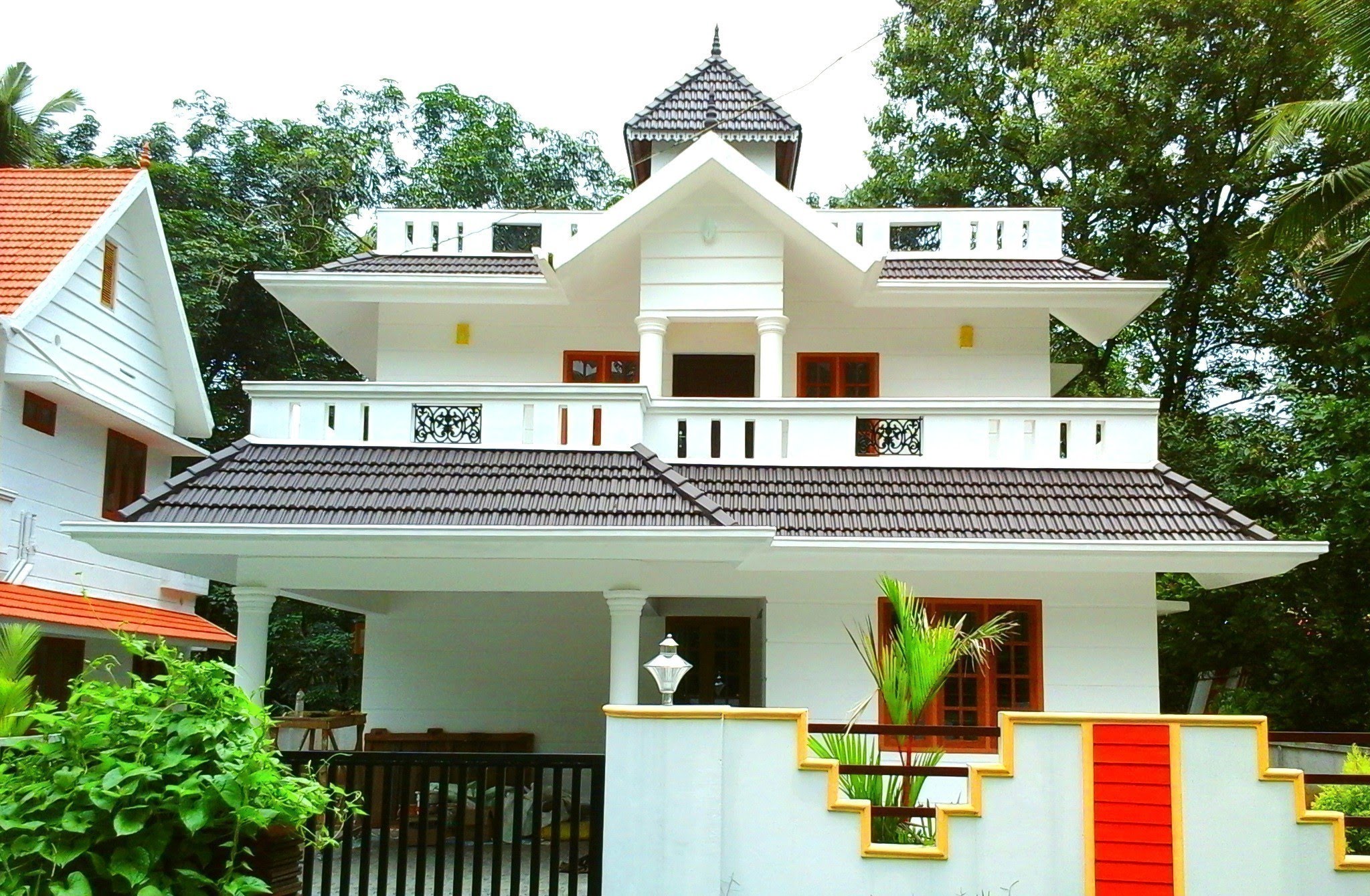 Sloped Roofs In A Kerala Style House Design 