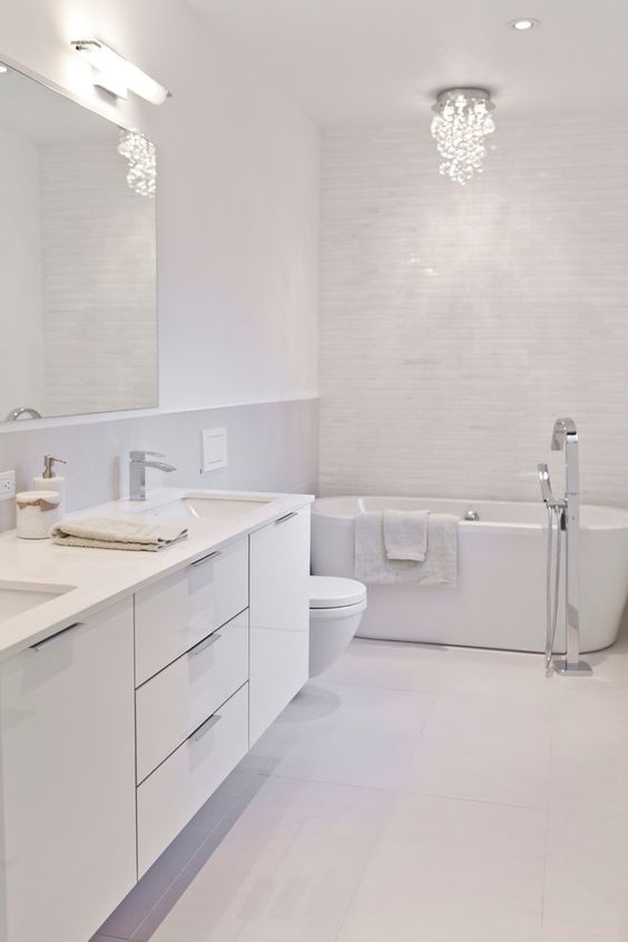 All white Bathroom starting from tiles, sanitary fittings to granite and storage units