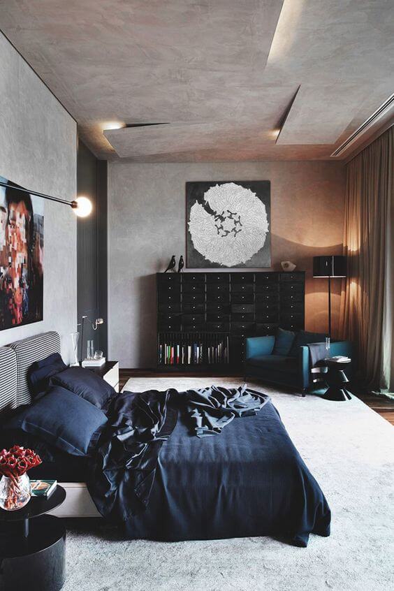 Bedroom of a bachelor pad with black bedsheets and interior