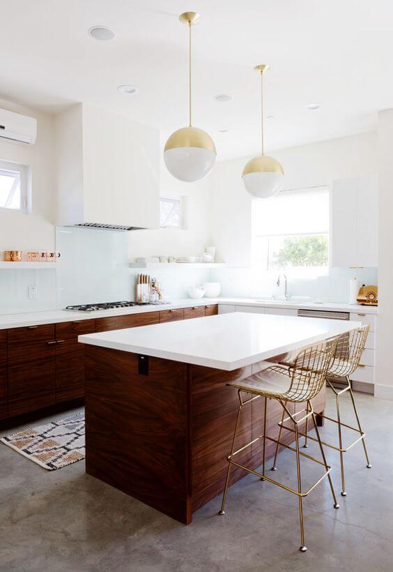 Island Kitchen with White Countertop, wooden color base structure and golden coloured bar stools