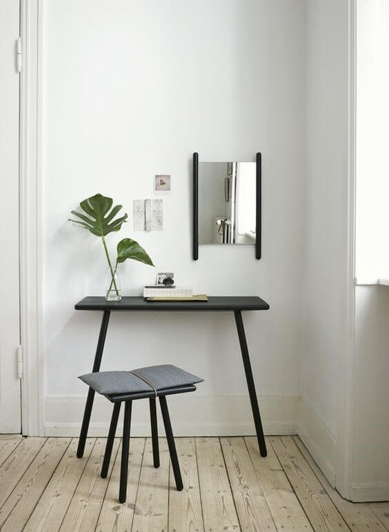 Minimalistic black study table with chair and vase