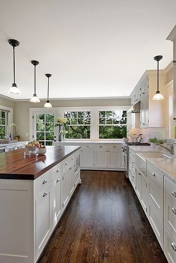 Wooden colored flooring in white and wooden design kitchen