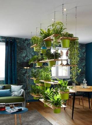 A hanging partition made of ropes and planters