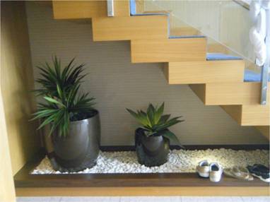Potted plants underneath the staircase