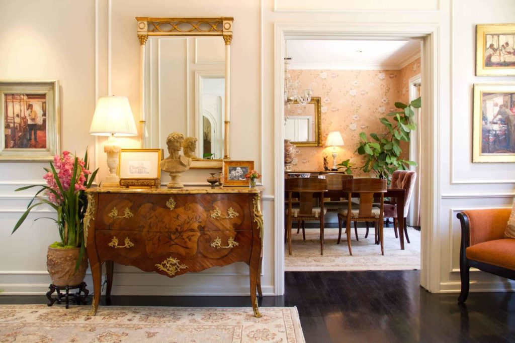 Antique styled furniture storage beneath mirror