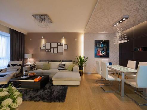 Brown color accent wall with lighting and photo frames placed in living room