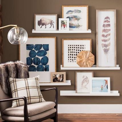 Brown colour accent wall with gallery frames in living room