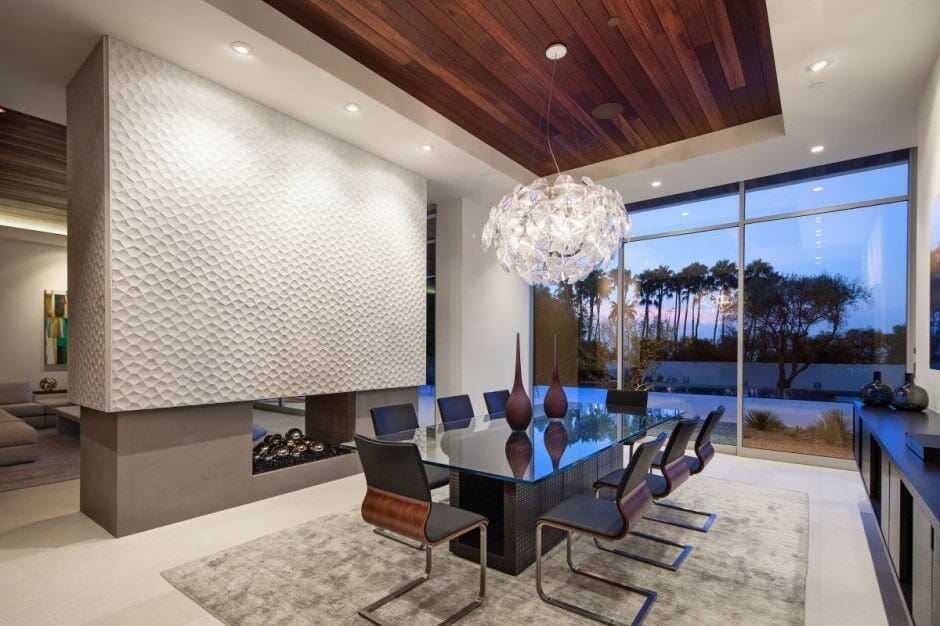 Wooden Ceiling with chandelier to give expensive look to dining area