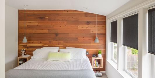 Wooden panel accent wall behind bed