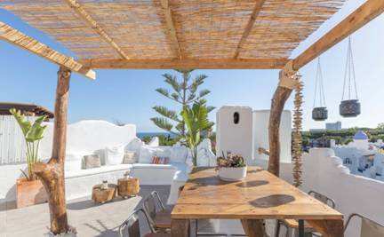 dining table on roof top with roof made out of bamboo sticks