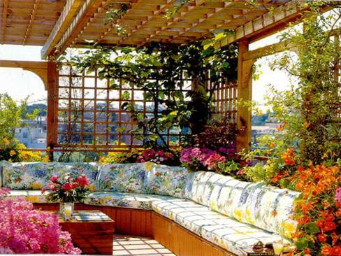 open air sofa with pergola and creepers installed on roof top