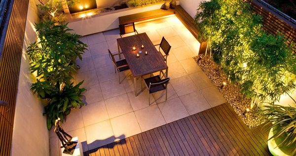 well lit roof top with dining tabl and garden-2