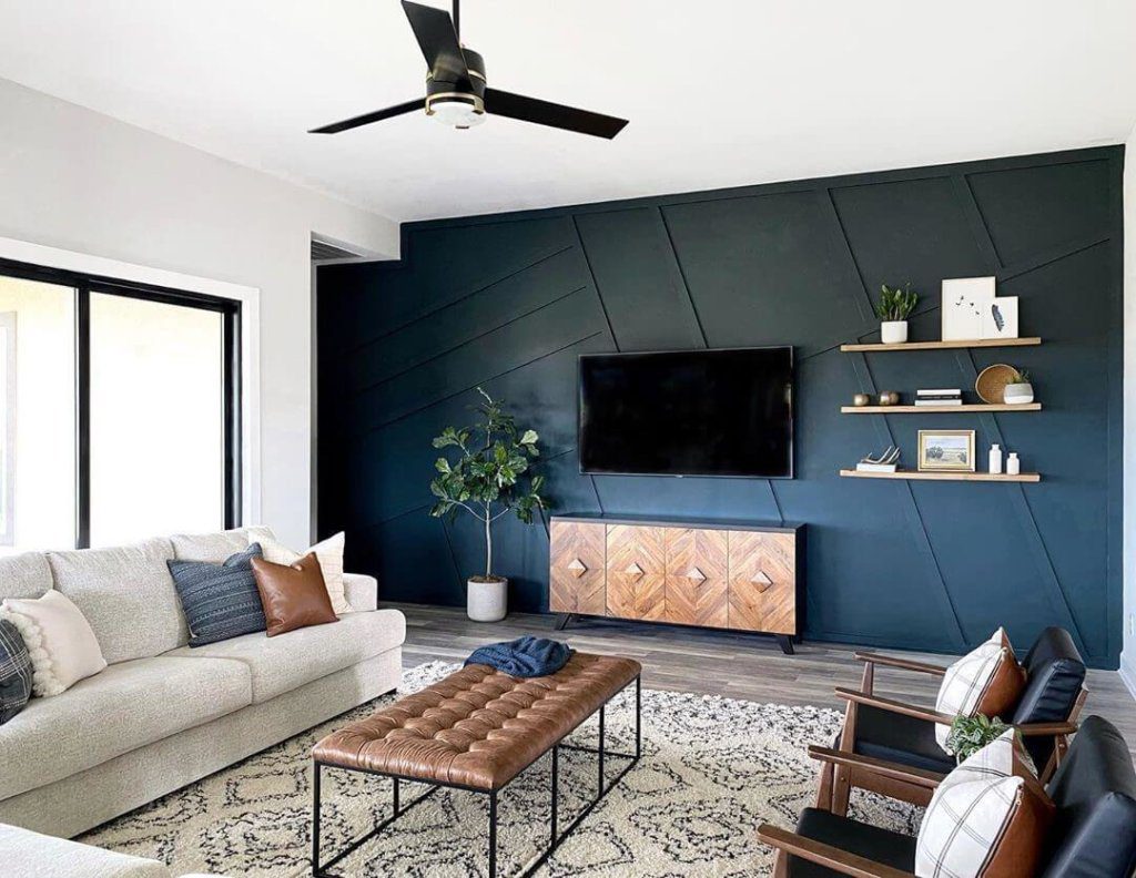 An Accent wall in blue color that enhances the living room interiors