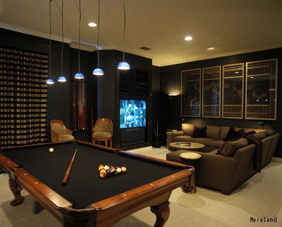 A entertainment den for men with a pool table and seating infront TV