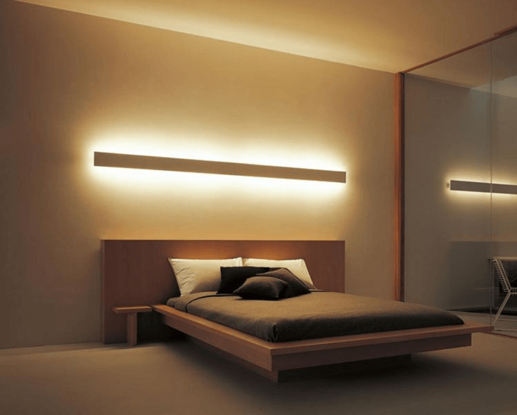 Light installed above headboard as a focal point in bedroom