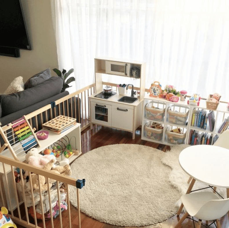 A segregated play area in the living room filled with toys