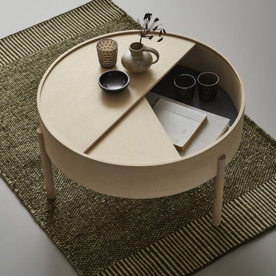 A hidden storage underneath the round coffee table top