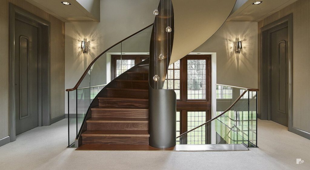 Helical staircase finished in wood and with Toughened glass handrails