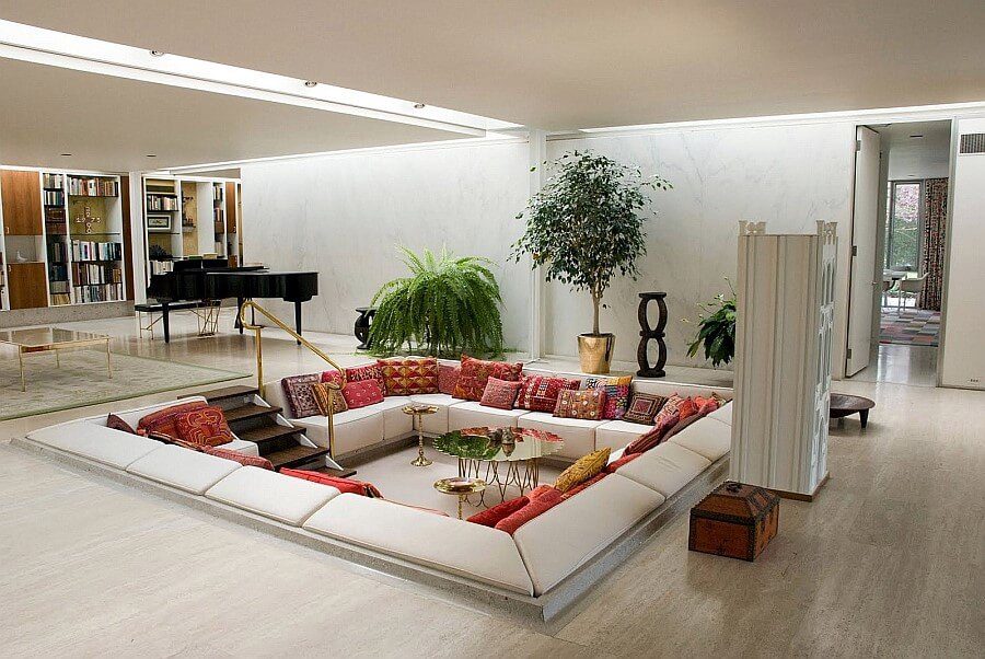 A defined sunken area in living room with sofa and sitting space