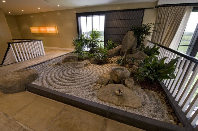 A interior zen garden created with rocks, gravel and small plants