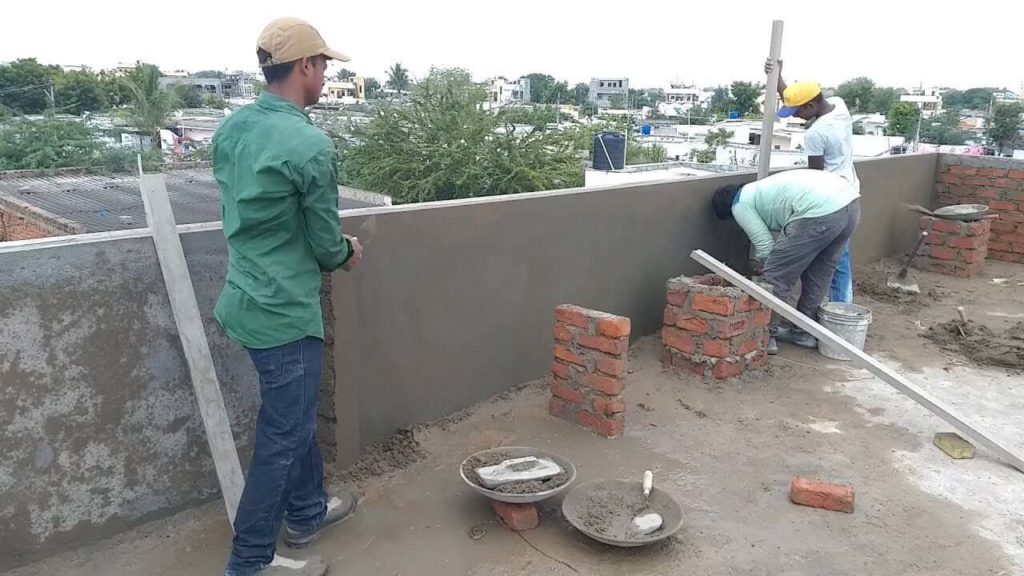 Construction and plastering of a brick parapet wall