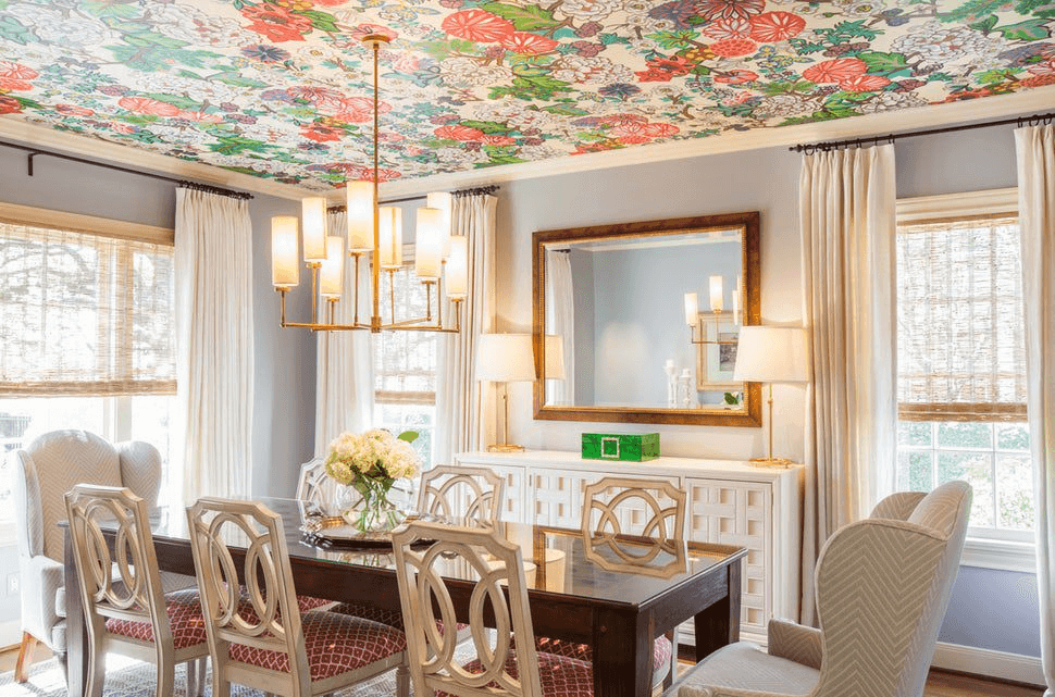 A floral wallpaper installed on the ceiling above the dining table