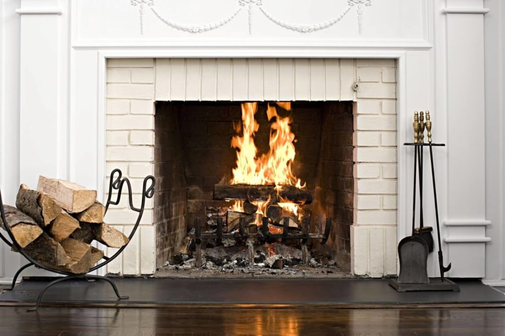 installed fireplace with burning fire and wooden