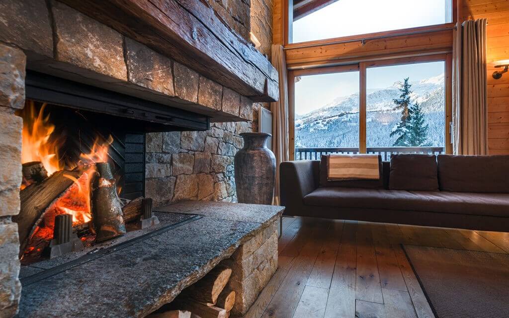 Fireplace with wooden interior finishing in living area