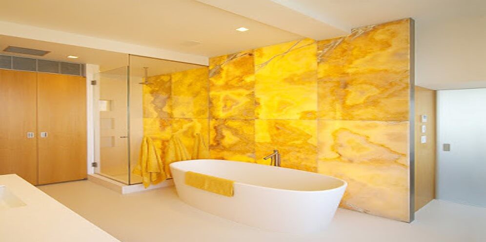 Image of Bathroom area with bathtub and yellow interior with yellow marble