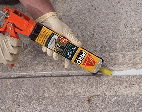 image of using caulk to fill the gaps in wall
